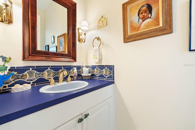 bathroom featuring vanity and tasteful backsplash