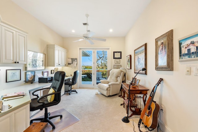 carpeted office space with ceiling fan