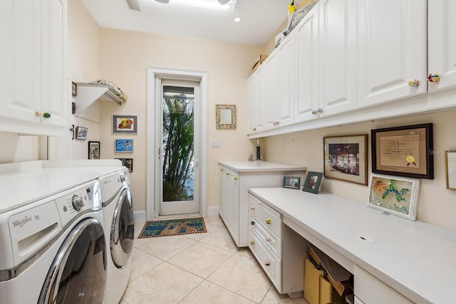 laundry area with washing machine and clothes dryer, light tile patterned floors, and cabinets