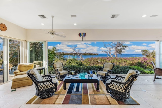 view of patio / terrace featuring ceiling fan, a water view, and an outdoor hangout area