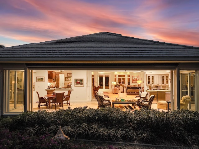 back house at dusk with french doors