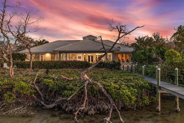 view of back house at dusk