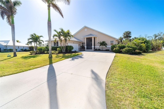 single story home featuring a garage and a front lawn