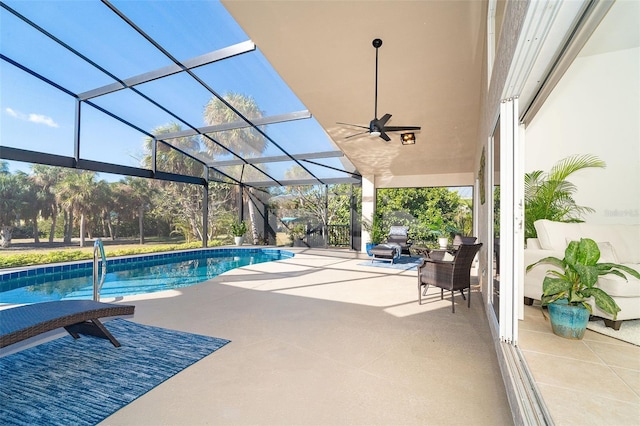 view of swimming pool featuring a patio, ceiling fan, and glass enclosure