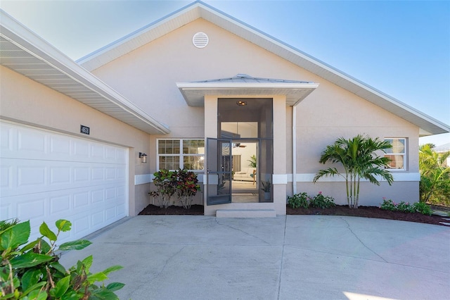 doorway to property with a garage