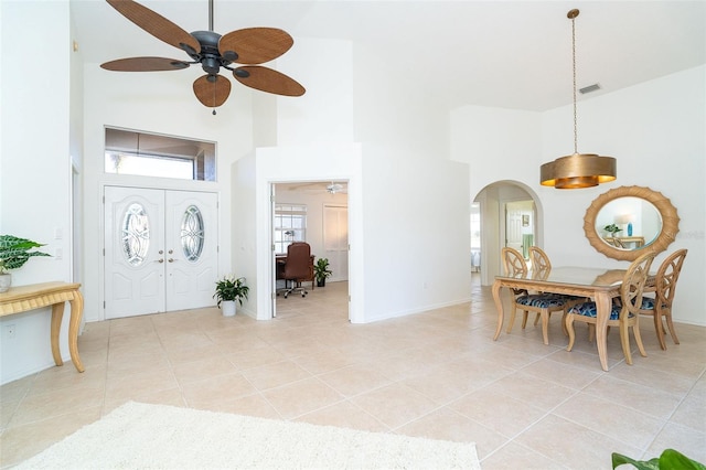 foyer entrance featuring light tile patterned flooring, ceiling fan, and high vaulted ceiling