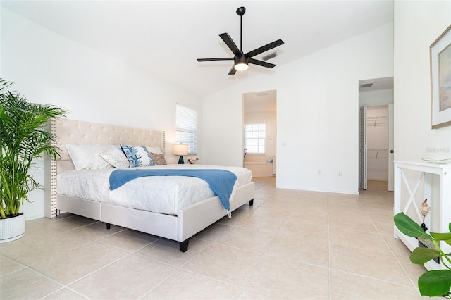 tiled bedroom featuring vaulted ceiling, ensuite bathroom, and ceiling fan