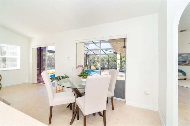 dining area featuring light tile patterned flooring and lofted ceiling