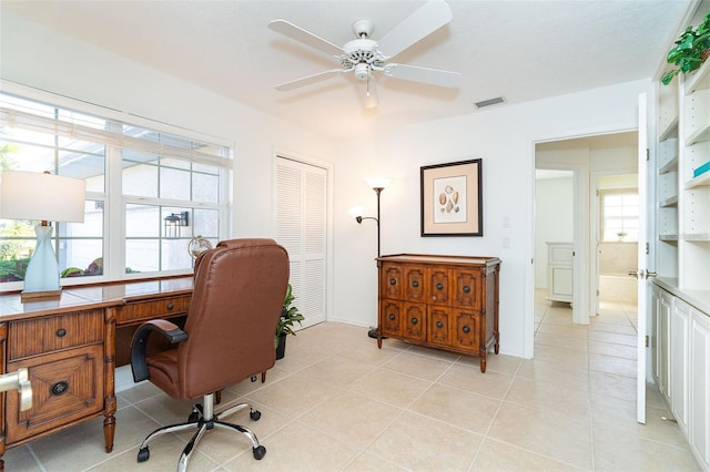 tiled office space featuring ceiling fan and plenty of natural light