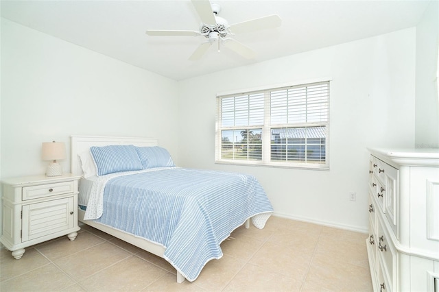 bedroom with ceiling fan and light tile patterned floors