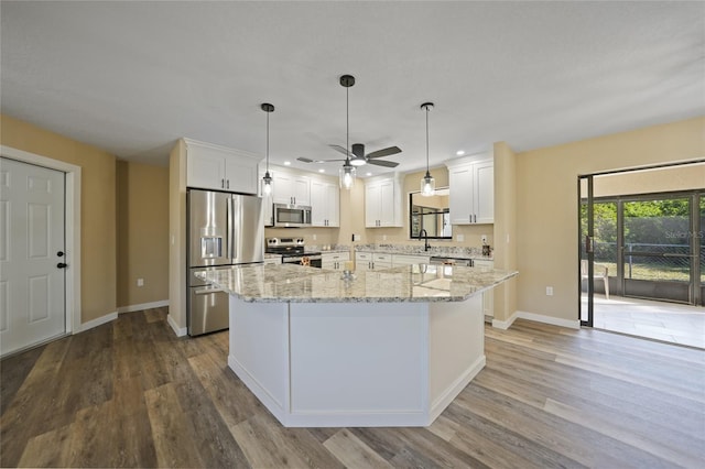 kitchen featuring white cabinets, wood-type flooring, sink, and appliances with stainless steel finishes