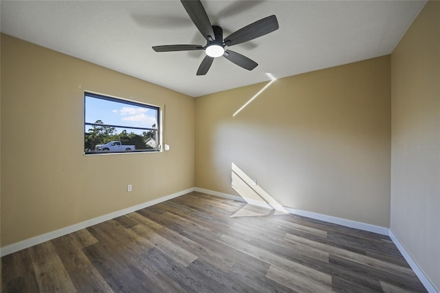 spare room with ceiling fan and dark hardwood / wood-style flooring