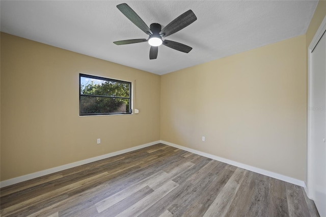 spare room with hardwood / wood-style floors and ceiling fan