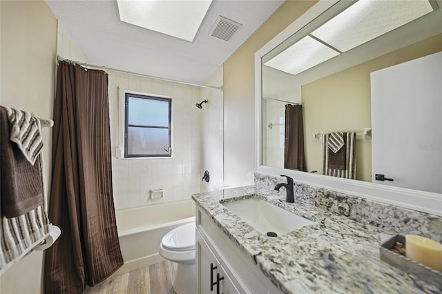 full bathroom featuring shower / tub combo, vanity, hardwood / wood-style flooring, and toilet