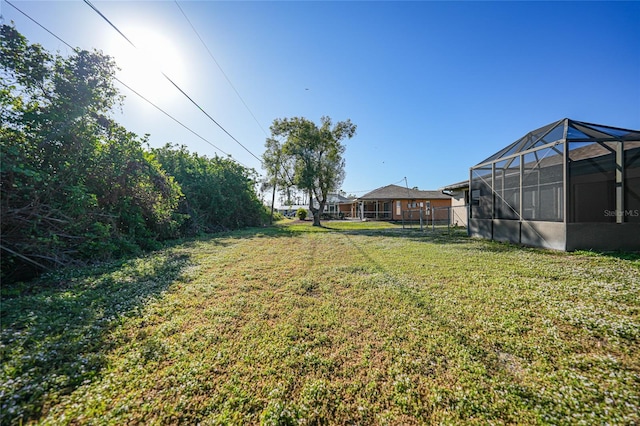 view of yard with a lanai