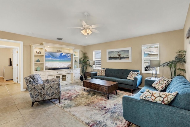 tiled living room featuring ceiling fan