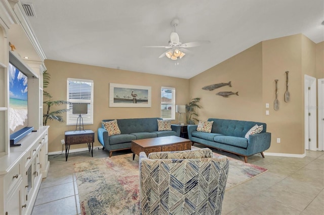 living room featuring ceiling fan, light tile patterned floors, and vaulted ceiling