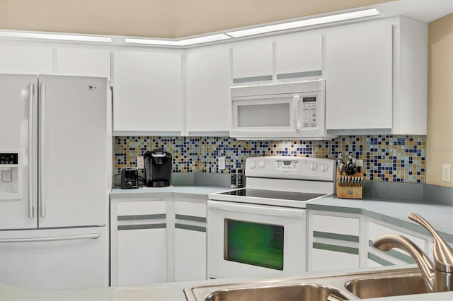 kitchen featuring white cabinetry, white appliances, sink, and decorative backsplash