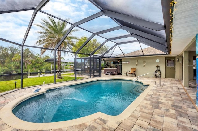 view of pool featuring glass enclosure, a patio area, a jacuzzi, and pool water feature