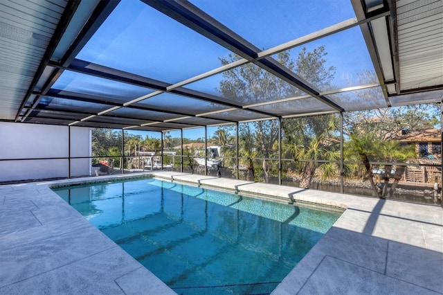 view of swimming pool featuring a patio area and a lanai