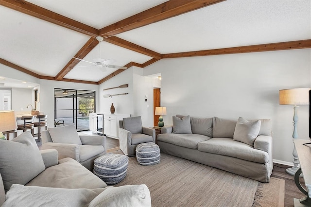 living room featuring ceiling fan, wood-type flooring, and lofted ceiling with beams