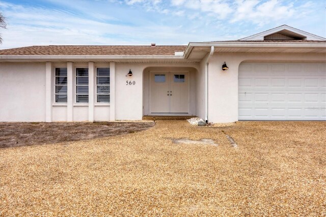 view of exterior entry featuring a garage