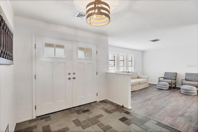 foyer featuring a textured ceiling