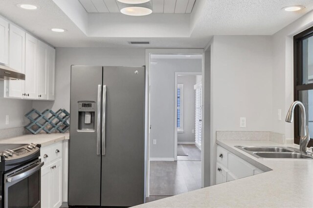 kitchen featuring sink, white cabinetry, appliances with stainless steel finishes, and a textured ceiling