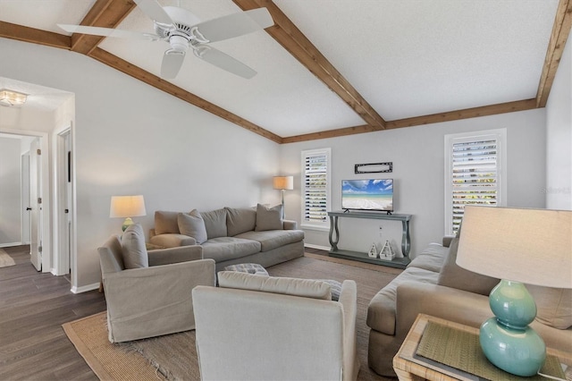 living room with ceiling fan, dark wood-type flooring, and lofted ceiling with beams