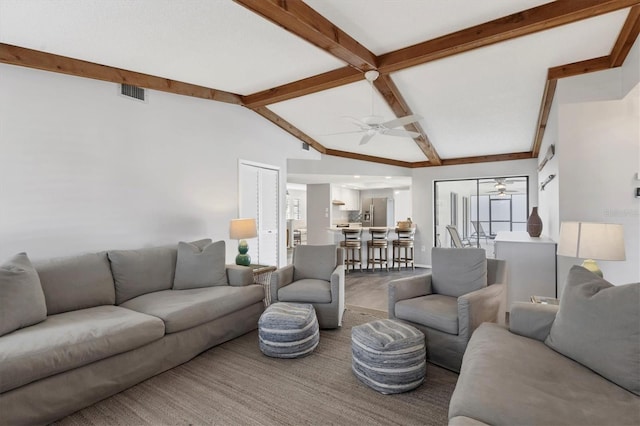 living room featuring ceiling fan, hardwood / wood-style floors, and lofted ceiling with beams