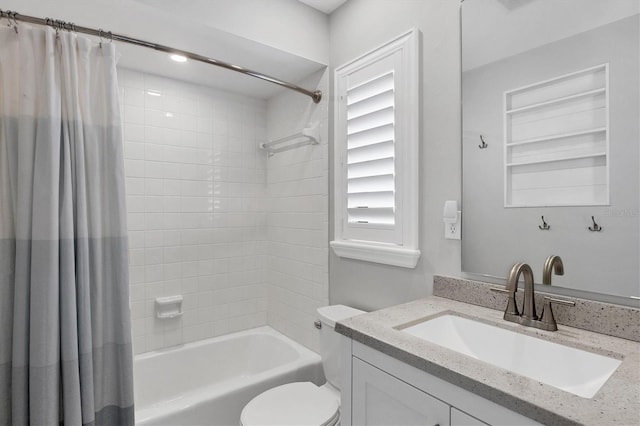 full bathroom featuring toilet, shower / bath combination with curtain, and vanity