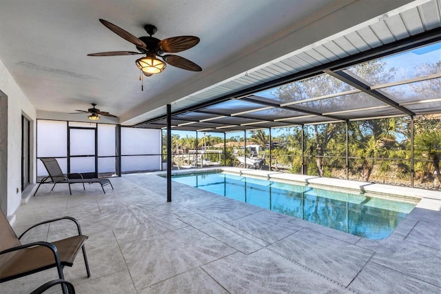 view of pool featuring glass enclosure and a patio