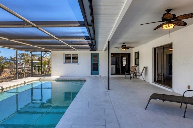 view of pool featuring ceiling fan, a lanai, and a patio area