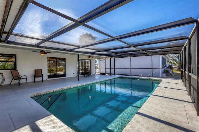 view of swimming pool featuring ceiling fan, a patio area, and a lanai