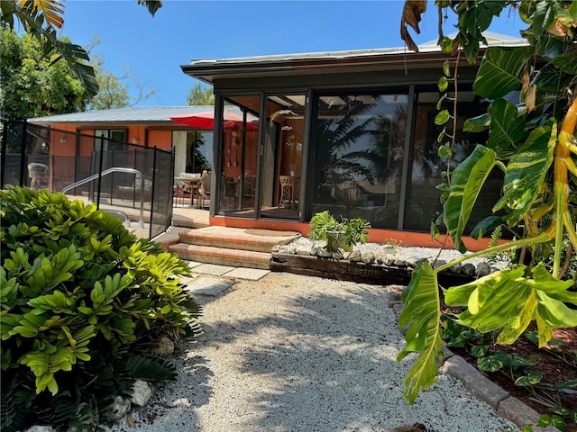 exterior space featuring a sunroom