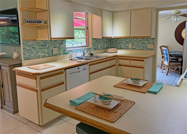 kitchen with sink, white dishwasher, and light tile patterned floors