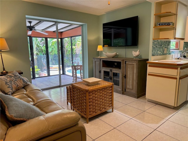 tiled living room with ceiling fan