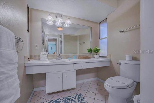 bathroom with tile patterned floors, vanity, and toilet