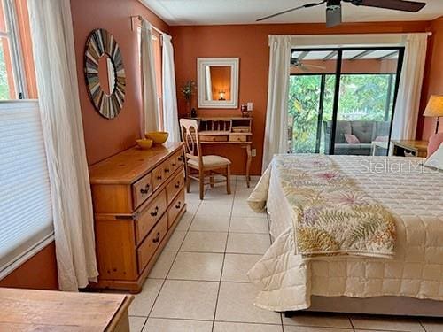 tiled bedroom featuring access to outside and ceiling fan