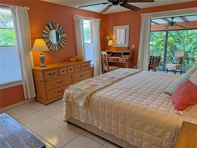 tiled bedroom featuring ceiling fan and multiple windows