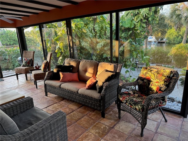 sunroom / solarium with beamed ceiling and ceiling fan