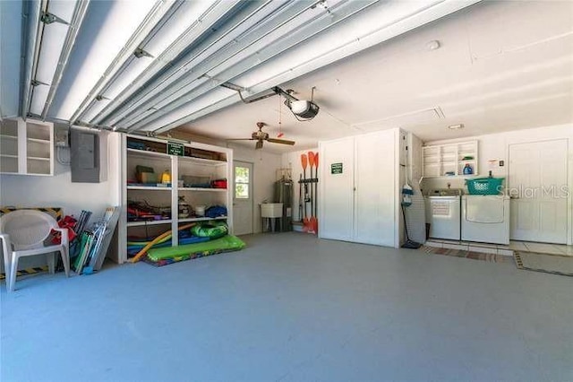 garage with electric panel, a garage door opener, washer and clothes dryer, and ceiling fan