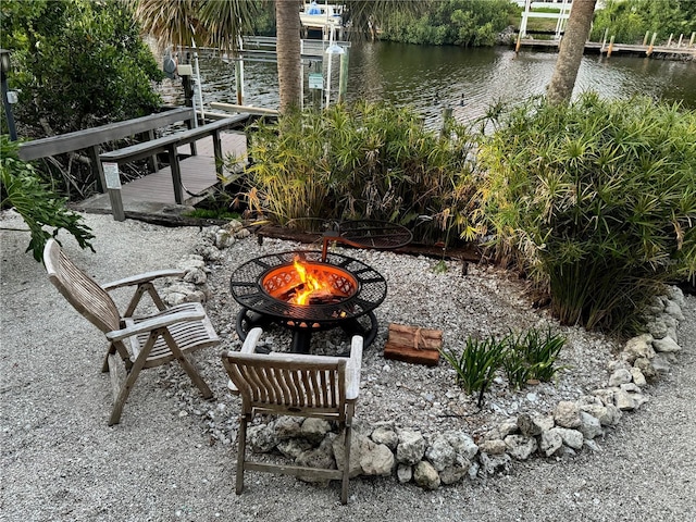 view of patio / terrace with a water view and a fire pit