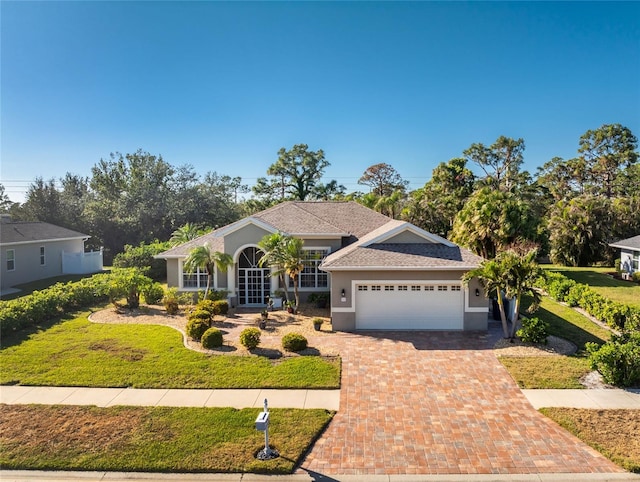 view of front of house with a front lawn and a garage