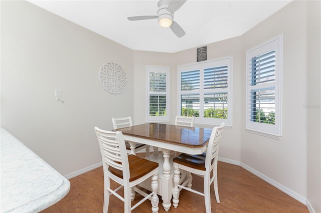 dining area featuring hardwood / wood-style flooring and ceiling fan