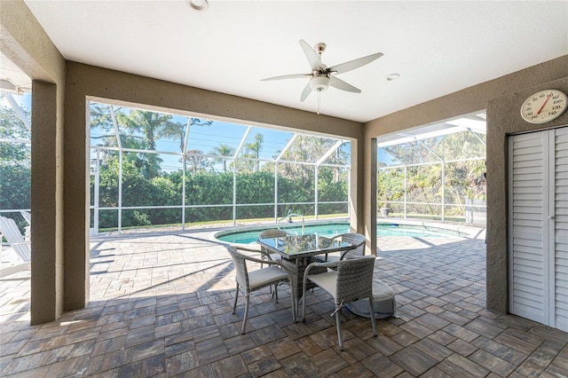 view of patio / terrace with ceiling fan and glass enclosure