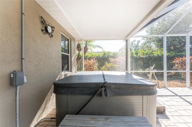 sunroom featuring a jacuzzi