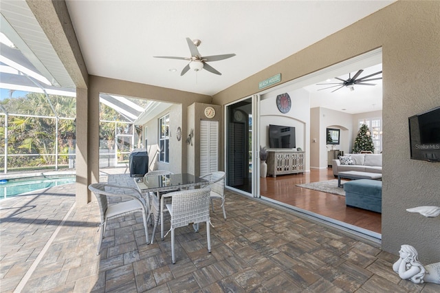 view of patio / terrace featuring a lanai and ceiling fan