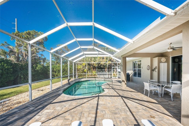 view of swimming pool featuring a lanai, ceiling fan, and a patio