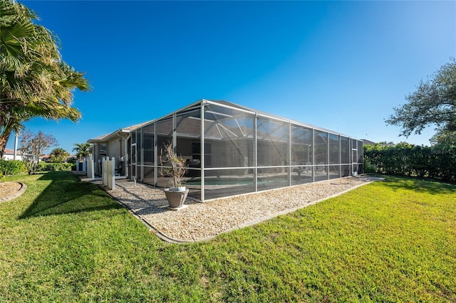 view of side of home with a lanai and a yard